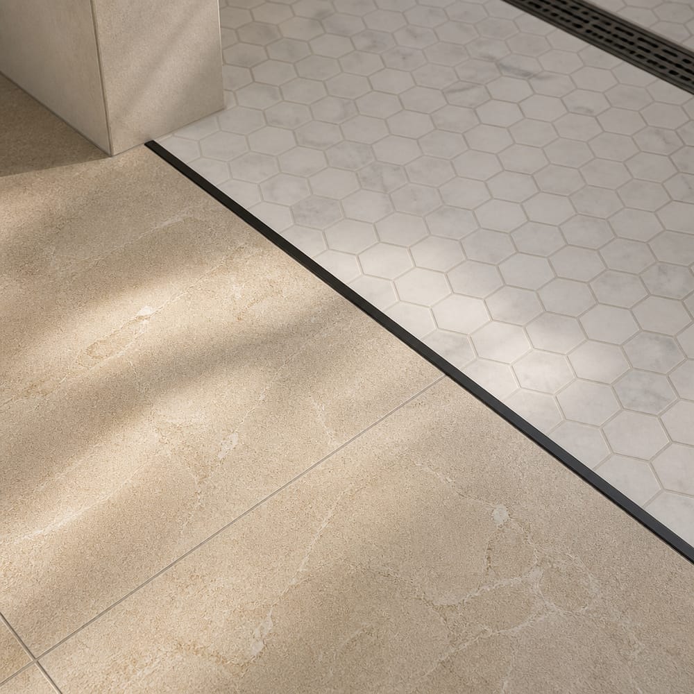 Floor tile transition at curbless shower entry