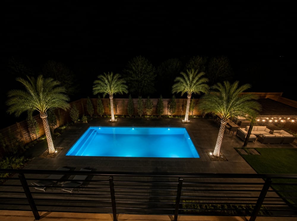 Pool perimeter uplights and overhead string-light canopy