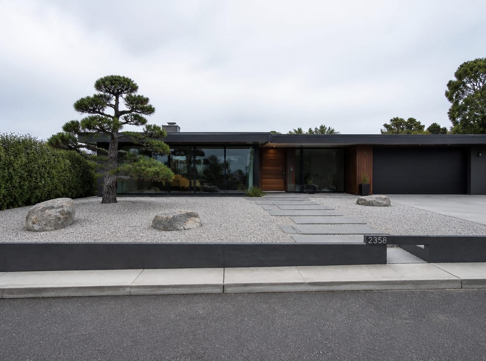 Pea gravel courtyard with boulders and bluestone path
