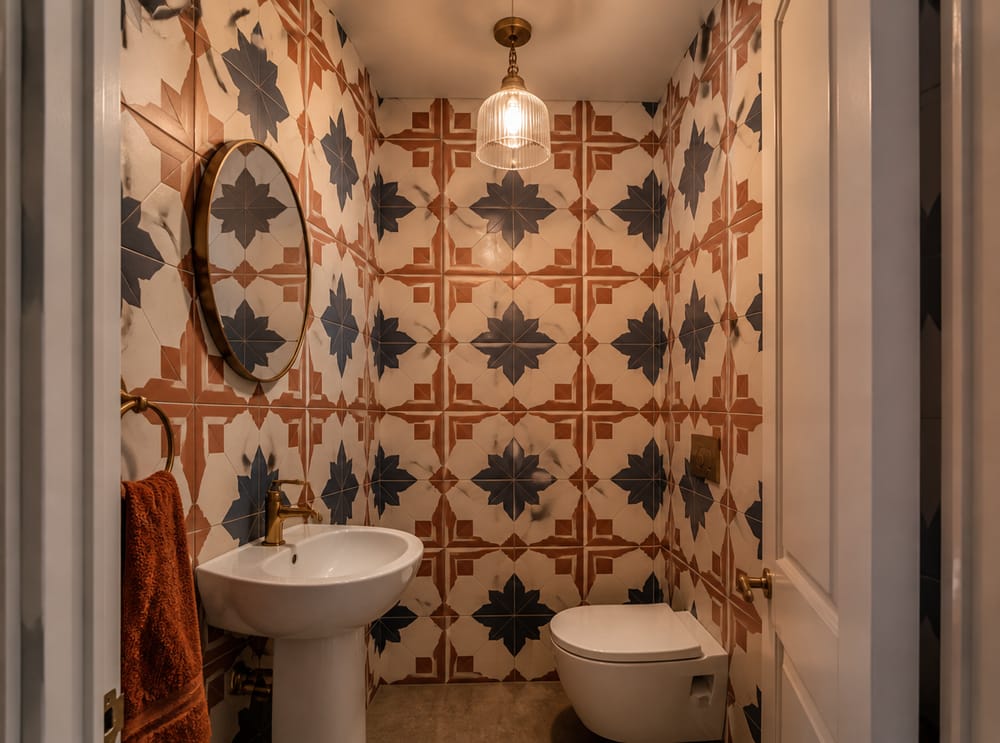 Bold encaustic pattern covering all four powder room walls
