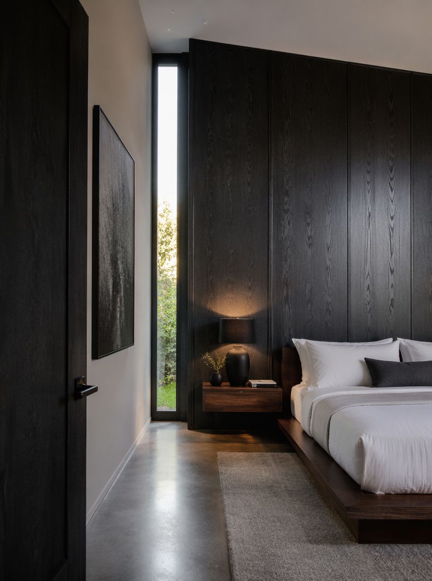 Charcoal oak panel wall behind white bedding