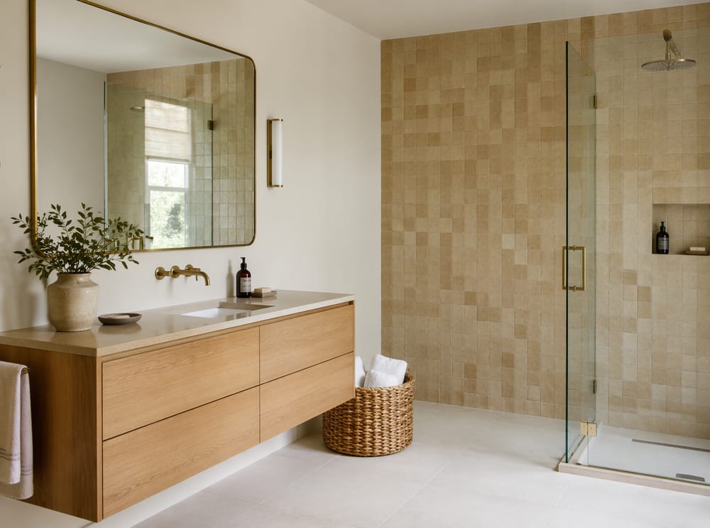 Oak vanity paired with sand-toned zellige tile