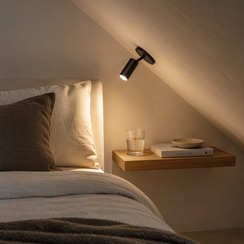 Wall-mounted reading light fixed to the angled ceiling surface