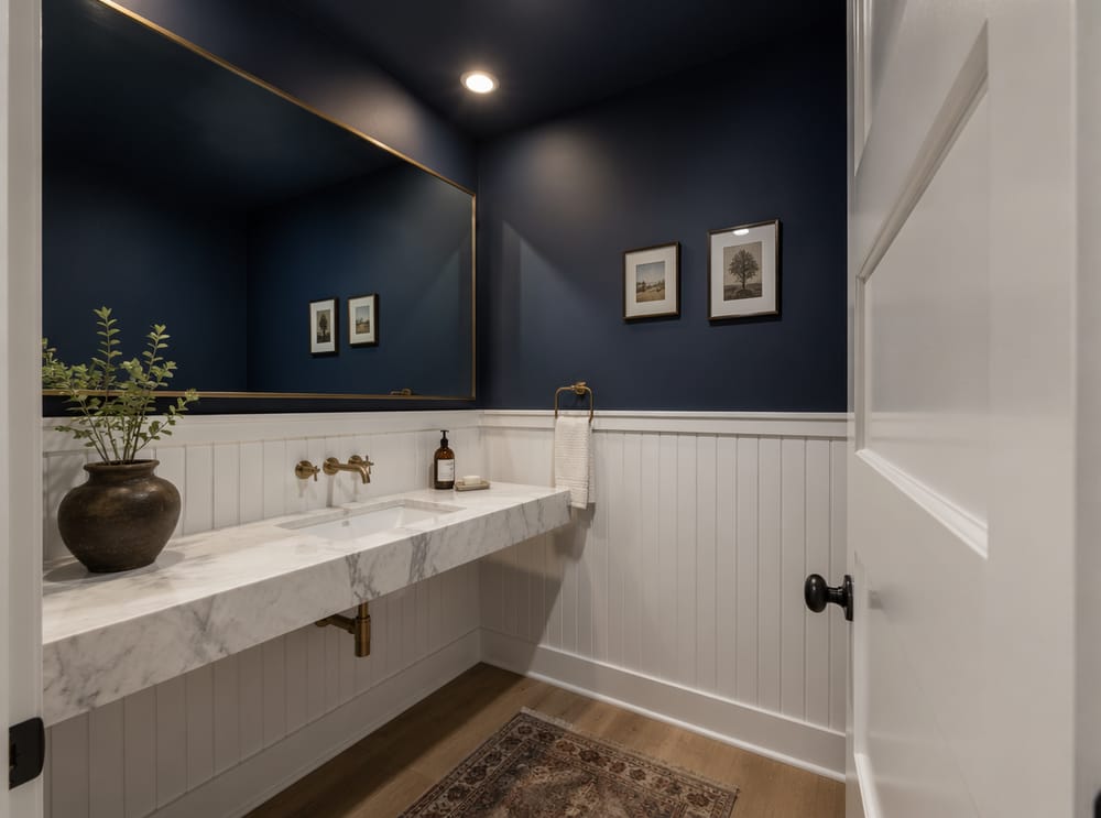 Carrara marble shelf with deep navy upper walls